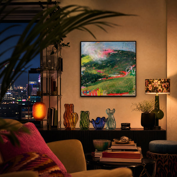 Small original expressionist landscape painting hanging in a styled interior